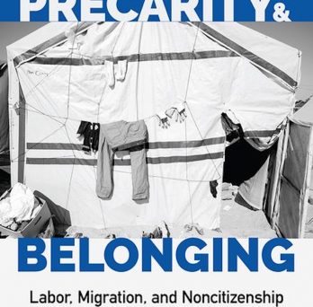 Blue and White book cover with a black and white imagery of clothes hanging on a cloth line in front of a tent
                  